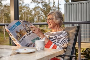 Woman reading newspaper at Renaissance