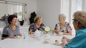 Ladies laughing eating scones