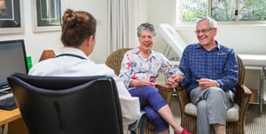 Man and woman talking with doctor at Renaissance